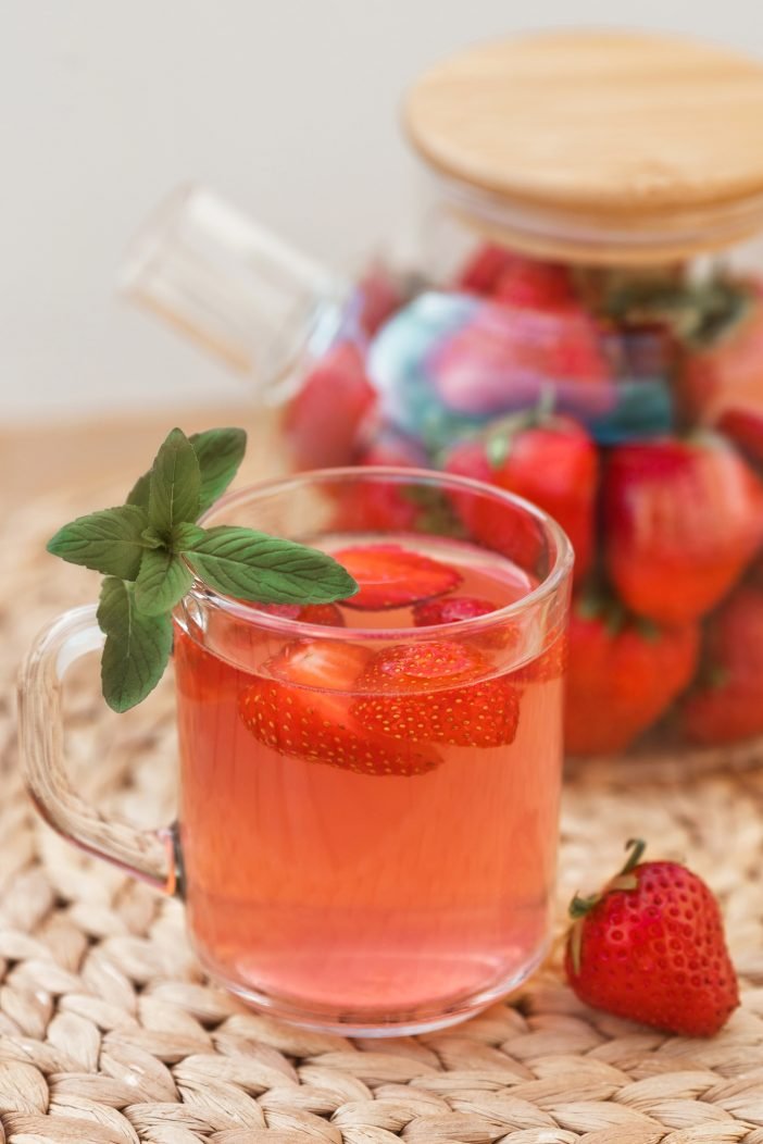 close-up-vertical-photo-of-strawberry-hot-tea-with-mint-in-cup-and-teapot.jpg